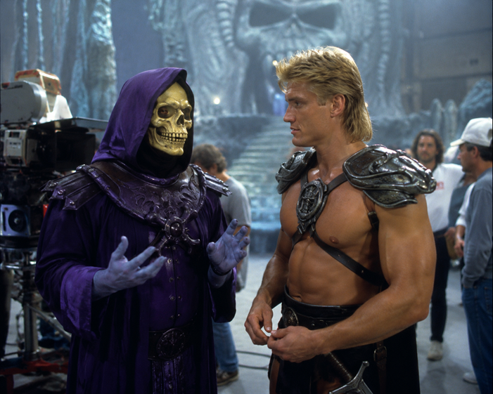 Behind-the-scenes image of Tricky D as Skeletor speaking with Dolph Lundgren as He-Man on the set of Masters of the Universe (1987).